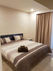 a bedroom with a large bed with a towel on it at Seven Seas Jomtien Dream in Jomtien Beach
