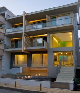 an apartment building with balconies and lights at Nefeli Apartments in Leptokaria