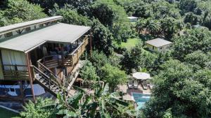 an aerial view of a house with a pool and trees at La Villa Te Fetia Nui Moorea in Teavaro