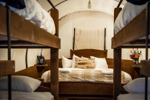 a bed with two bunk beds in a room at Conestoga Ranch Glamping Resort in Garden City