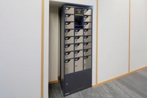 a walk in closet with a black cabinet with drawers at karaksa hotel Sapporo in Sapporo