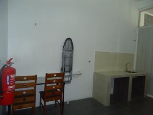 a room with a sink and a desk and a fire hydrant at VillaSetia in Kampong Gong Badak
