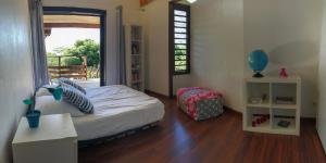 Postel nebo postele na pokoji v ubytování La Villa Te Fetia Nui Moorea