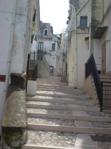 an alley with steep stairs in an old town at Residence Ducale in Rodi Garganico