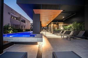 a hotel with a swimming pool and a building at Atlas Apartments by CLLIX in Brisbane