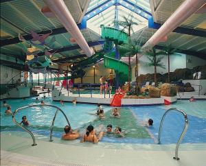 a group of people in a swimming pool at Caravan by the sea Trecco Bay in Porthcawl +5 photos