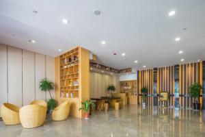 a lobby with chairs and tables in a building at Metropolo Hangzhou West Lake Culture Square in Hangzhou