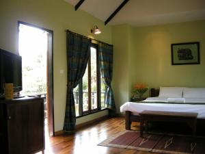 a bedroom with a bed and a large window at Baan Thai House in Phra Nakhon Si Ayutthaya