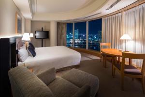 a hotel room with a large bed and a large window at The Yokohama Bay Hotel Tokyu in Yokohama