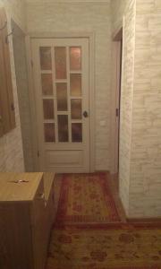 a room with a door with a window and a rug at Apartment Chernihivska 13 in Shostka