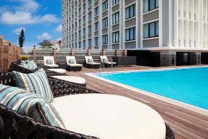 a hotel patio with chairs and a swimming pool at Hyatt Regency Naha, Okinawa in Naha