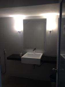 a bathroom with a white sink and a mirror at Festival Boutique Hotel @ Kampung Pandan in Kuala Lumpur