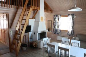 a dining room with a table and a fireplace at Youth Center Vasatokka in Inari +41 photos