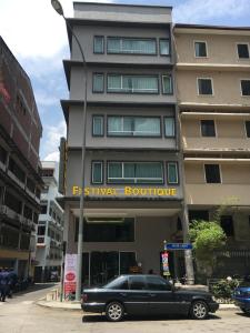 a black limousine parked in front of a building at Festival Boutique Hotel - Damai Complex in Kuala Lumpur +14 photos
