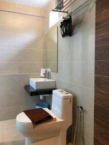 a bathroom with a white toilet and a sink at Festival Boutique Hotel - Damai Complex in Kuala Lumpur