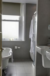 
a bathroom with a toilet, sink and tub at Best Western Plus Ilkley Craiglands Hotel & Spa in Ilkley
