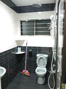 a bathroom with a toilet and a sink at Lot 4 PD Villa in Port Dickson