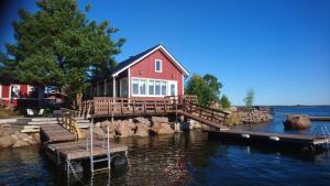 a house on a dock in the water at Rantakari Cottage in Kotka