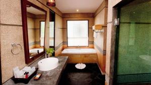 a bathroom with a tub and a toilet and a sink at Railay Village Resort in Railay Beach