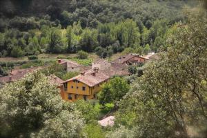 a group of houses on a hill with trees at Casa Senderuela in Panzares