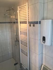 a shower with a glass door in a bathroom at Am Ringwall 76 in Cuxhaven