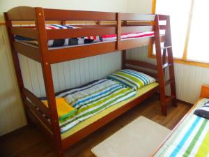 two bunk beds in a room with at Hovirag apartman 2 in Hajdúszoboszló