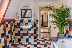 a bathroom with a sink and a colorful tile floor at The Livingrooms Laren in Laren