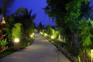 a walkway with lights on the side of a building at Baan Thai House in Phra Nakhon Si Ayutthaya