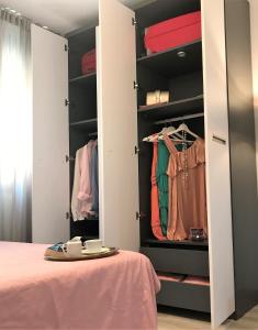 a bedroom with a closet with a surfboard on a bed at Estudio Alicante Centro in Alicante