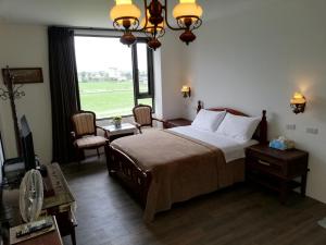 Postel nebo postele na pokoji v ubytování Tata House B&B