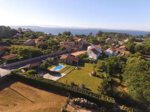 an aerial view of a house with a yard at Casa Rústica Piscina, Apartadiño in Pobra do Caramiñal