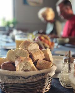 a basket of bread sitting on a table at La Villa in Mesnil-Val-Plage