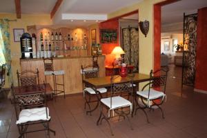 a dining room with a table and chairs at Hôtel Le Clos des Pins in Six-Fours-les-Plages