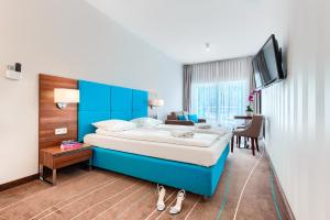 Posteľ alebo postele v izbe v ubytovaní Apartamenty AmberHome