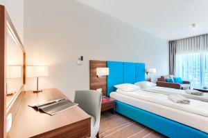 Posteľ alebo postele v izbe v ubytovaní Apartamenty AmberHome