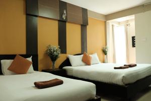 Postel nebo postele na pokoji v ubytování Puangpech Place