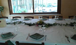 a table with a white table cloth and flowers on it at Valle Dei Pini in Lenola