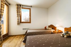 Ένα ή περισσότερα κρεβάτια σε δωμάτιο στο travelski home select - Résidence L'Arollaie +11 φωτογραφίες