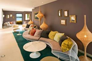 a living room with a couch and a table at Martinhal Sagres Beach Family Resort Hotel in Sagres