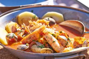 a bowl of food with shrimp and other vegetables at Martinhal Sagres Beach Family Resort Hotel in Sagres