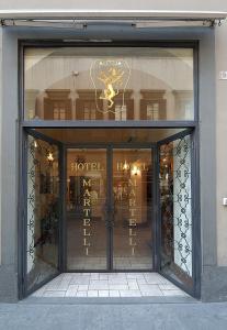a store front with the door of a hotel at Hotel Martelli in Florence