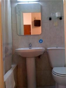 y baño con lavabo, aseo y espejo. en Hostal Excelsior, en Madrid