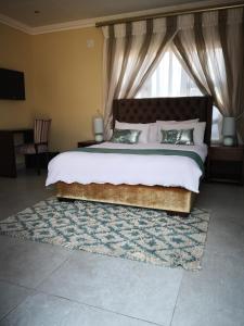 A bed or beds in a room at Mmakgabo Boutique Lodge