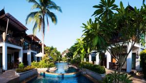 a resort with a swimming pool and palm trees at Railay Village Resort in Railay Beach