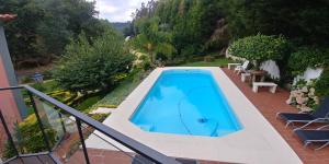 a swimming pool on the side of a house at Quinta das Águias in Aveiro
