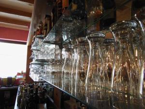 a bunch of wine glasses are lined up on a shelf at Triebener-Hor in Quierschied