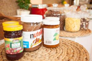 a group of jars of food on a table at Hotel Taxis Bratislava in Bratislava