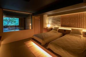 En eller flere senge i et værelse på Watei Kazekomichi