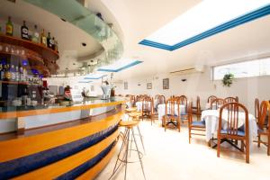 a bar in a restaurant with wooden counter and chairs at Apartamentos Pez Azul in Puerto de la Cruz