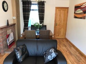 a living room with a leather couch and a table at Mountain View in Newcastle